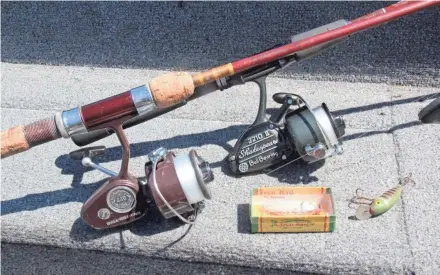  ??  ?? Fishing reels, rods and lures made in the 1950s and ’60s rest on the console of a boat during a 2018 outing in northweste­rn Wisconsin.