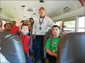  ?? DAN SOKIL — DIGITAL FIRST MEDIA ?? North Penn School District bus driver Jim Allebach, center, poses with students headed to Gwynedd Square Elementary School on Allebach’s final day of a 51-year career with the district.