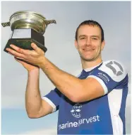  ??  ?? Scotland captain Finlay MacRae holds aloft the Marine Harvest Challenge Quaich.