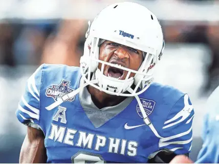  ?? MARK WEBER / THE COMMERCIAL APPEAL ?? Memphis receiver Anthony Miller celebrates a 68-yard touchdown against UCF during second-quarter action of the AAC Championsh­ip on Saturday in Orlando, Fla.
