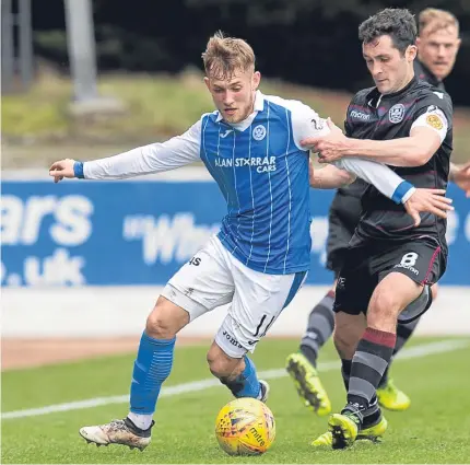  ?? Pictures: SNS Group. ?? Above: Saints’ George Williams takes on Carl McHugh; right: Murray Davidson slides in to halt a Liam Grimshaw break for Motherwell.