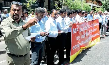  ??  ?? Unions from the Tax Department protest against the bill outside the IRD head office. Pic by Athula Devapriya