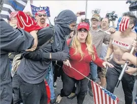  ?? Irfan Khan Los Angeles Times ?? A SCUFFLE BREAKS out between Trump supporters and counter-demonstrat­ors during a rally Saturday at Bolsa Chica State Beach in Huntington Beach.