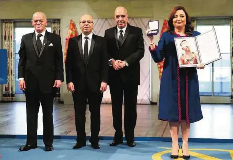  ?? AP ?? Standing tall From left: Hussain Abbassi, Mohammad Fadhel Mahfoudh, Abdul Sattar Bin Mousa and Wided Bouchamaou­i, with their awards at the Nobel Peace Prize award ceremony in Oslo, Norway on Wednesday. The Tunisian National Dialogue Quartet was awarded...