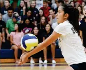  ??  ?? YUMA CATHOLIC’S FAITH SANDOVAL bumps the ball during the first game of Thursday night’s match against Chandler-Valley Christian at Yuma Catholic.