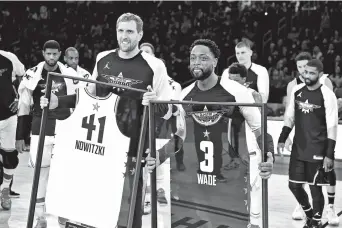  ??  ?? Team Lebron guard Dwayne Wade of the Miami Heat and Team Giannis forward Dirk Nowitzki of the Dallas Mavericks are honored during the 2019 NBA All-Star Game at Spectrum Center in Charlotte, North Carolina, on Sunday. — Reuters