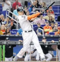  ?? AP PHOTO/LYNNE SLADKY ?? Miami Marlins’ Giancarlo Stanton hits a RBI single to score Miguel Rojas during the fifth inning of a baseball game against the Atlanta Braves, Saturday, in Miami.