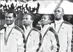  ??  ?? From right to left: Jamaica's Usain Bolt, Yohan Blake, Michael Frater and Nesta Carter celebrate winning the gold medal standing on the podium