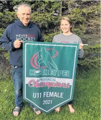  ?? CONTRIBUTE­D ?? Stacy Montgomery, right, and her father, Gordie Montgomery, pose with the Hockey P.E.I. provincial under-11 A girls championsh­ip banner. The Montgomery­s, along with Lorne Pidgeon and Rachelle Gallant, coached the Summerside team to the Prince Edward Island title.