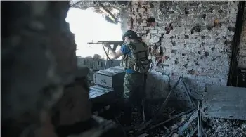  ?? Mstyslav Chernov/The Associated Press ?? A Russia-backed rebel fires at Ukrainian army positions at Donetsk airport in eastern Ukraine on Tuesday. More than 2.2 million people have fled eastern Ukraine since last year.