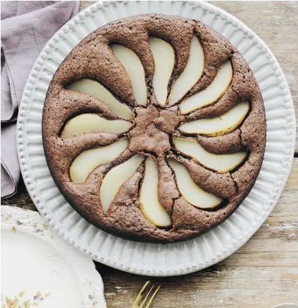  ?? LAUREN BAMFORD/HARDIE GRANT/CHRONICLE BOOKS ?? This pear and chocolate dessert “is a very forgiving cake,” writes Emiko Davies in Florentine.