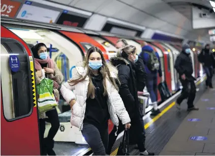  ?? PHOTO: REUTERS ?? People leave a train at the Victoria tube station as Covid19 rages in London this week.