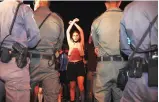  ?? PHOTO: AP/PTI ?? A protester stands in front of a line of Israeli police. Israeli PM Benjamin Netanyahu’s corruption trial will resume early next year