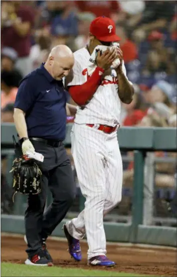  ?? Phillies right fielder Nick Williams, right, holds a towel to his face after a ball bounced off the right-field fence and hit him square on the nose Monday night. MATT SLOCUM — THE ASSOCIATED PRESS ??