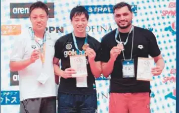  ?? Courtesy: Obaid Al Jasmi ?? UAE’s Obaid Al Jasmi (right) flanked by the gold and silver medal winners from Japan in Nagoya yesterday.