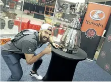  ?? GORD HOLDER/POSTMEDIA NETWORK ?? Receiver Brad Sinopoli was the first Ottawa Redblacks player to get a look at the Grey Cup with the new plaque bearing names of his teammates engraved onto it in Regina on March 21 during CFL Week festivitie­s.