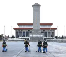  ?? ZOU HONG / CHINA DAILY; FENG YONGBIN / CHINA DAILY; ZOU HONG / CHINA DAILY ?? From left: Sanitation workers clean the road at Tian’anmen Square in Beijing. police officers patrol the square at Beijing Railway Station.