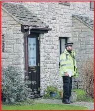  ??  ?? ON GUARD: Police outside suspect’s home