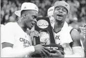  ?? STREETER LECKA/GETTY ?? Lagerald Vick, left, and Malik Newman celebrate Kansas’ victory. Newman scored all 13 of the Jayhawks’ points in OT.