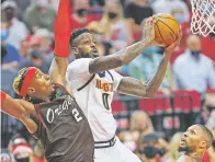  ?? CRAIG MITCHELLDY­ER/ASSOCIATED PRESS ?? Nuggets forward JaMychal Green shoots next to Trail Blazers forward Rondae Hollis-Jefferson on Thursday in Portland, Ore. The Nuggets won the first-round series 4-2.