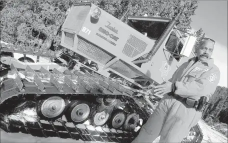  ?? Hyoung Chang Denver Post ?? A TUCKER SNO-CAT is shown next to Jefferson County Sheriff ’s Deputy Mike Sensano in Evergreen, Colo., in December 2003. Demand for the machines — both new and used — is peaking, thanks to aff luent landowners, classic collectors and gearheads with a...