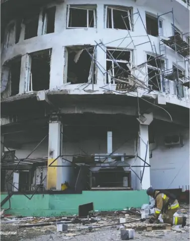  ?? UKRAINE'S STATE EMERGENCY SERVICE ?? A worker examines debris in the aftermath of a Russian drone attack on the Black Sea city of Mykolaiv on Saturday.