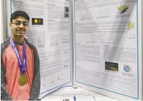  ?? ALI RIZVI ?? Campbell Collegiate Grade 10 student Ali Rizvi with his project display at the Canada-wide Science Fair in Fredericto­n this month. Rizvi won a gold medal for his project on finding exoplanets using computer algorithms.