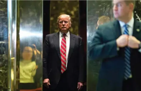  ?? DOMINICK REUTER/AFP/GETTY IMAGES ?? U.S. president-elect Donald Trump boards the elevator after escorting Martin Luther King III to the lobby following a meeting at Trump Tower.