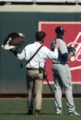  ?? JEFF WHEELER/ STAR TRIBUNE ?? The handler for an American eagle that was to fly to the pitcher’s mound during the national anthem pats Seattle Mariners starting pitcher James Paxton, a Canadian, after the eagle chose to land on Paxton’s shoulder instead before Thursday’s game...