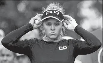  ?? CP PHOTO ?? Brooke Henderson adjusts her visor at the first hole during the 2017 CP Women’s Open of the LPGA Tour in Ottawa.