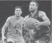  ?? JOE RONDONE/THE REPUBLIC ?? Warriors guard Stephen Curry scored 50 points on Devin Booker and the Suns on Wednesday night at Footprint Center in Phoenlx. The Suns won 130-119.