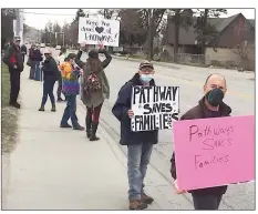  ??  ?? Peaceful protesters line outside the Pathways Addictions Resource Centre offices in Penticton on Sunday, March 28, 2021.