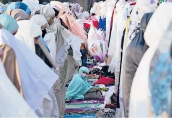  ?? TATAN SYUFLANA/AP ?? Muslim women offer Eid al-Fitr prayers Monday to mark the end of the holy fasting month of Ramadan in Jakarta, Indonesia. Muslims around the world are observing Eid — typically marked with communal prayers, celebrator­y gatherings around festive meals and new clothes — in the shadow of a surge in global food prices exacerbate­d by the war in Ukraine.