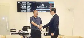  ??  ?? An LMI client shakes hands with Raymond Rodriguez at the showroom’s welcoming service reception area.