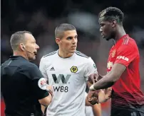  ?? Reuters ?? Manchester United’s Paul Pogba and Wolverhamp­ton Wanderers’ Conor Coady speak with referee Kevin Friend. —