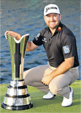  ??  ?? Winning smile: Graeme Mcdowell poses with the Saudi Internatio­nal trophy