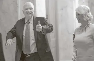  ?? Win McNamee / Getty Images ?? Sen. John McCain, R-Ariz., who was recently diagnosed with brain cancer, returned to the Senate on Tuesday with his wife, Cindy, to vote in favor of beginning debate on the GOP health-care bill.