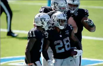  ?? AP Photo/Brian Blanco ?? Las Vegas Raiders running back Josh Jacobs (28) celebrates after scoring during the second half of an NFL football game against the Carolina Panthers on Sunday in Charlotte, N.C.