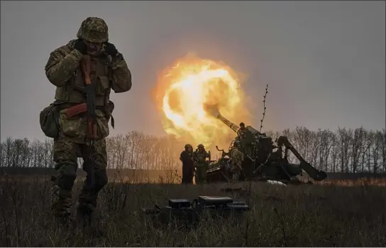  ?? LIBKOS — THE ASSOCIATED PRESS FILE ?? Ukrainian soldiers fire a Pion artillery system at Russian positions near Bakhmut, Donetsk region, Ukraine, on Dec. 16. As milestones go, the first anniversar­y of Russia’s invasion of Ukraine is both grim and vexing. It marks a full year of killing, destructio­n, loss and pain felt even beyond the borders of Russia and Ukraine.