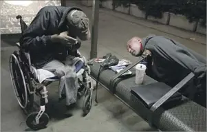  ??  ?? OUTREACH WORKER Anthony Ruffin, right, checks on Eddie “Snake” Carter, a 65year-old double amputee. Ruffin estimates that since 2008, about 40 of his clients have died.