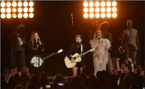  ?? RICK DIAMOND — GETTY IMAGES ?? Beyonce, right, performs with Emily Robison and Natalie Maines of Dixie Chicks at the 50th annual CMA Awards on Nov. 2, 2016 in Nashville, Tenn.