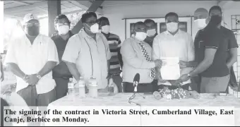  ??  ?? The signing of the contract in Victoria Street, Cumberland Village, East Canje, Berbice on Monday.