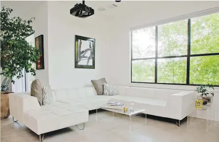  ?? — THE ASSOCIATED PRESS ?? This room is decorated with a variety of acrylic tables, including a coffee table and end tables. Clear furniture can make a room seem lighter, brighter, and less cluttered.