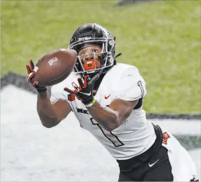  ?? Marco Garcia The Associated Press ?? UNLV freshman Kyle Williams had a strong performanc­e with 10 catches for 144 yards, including a 19-yard touchdown.