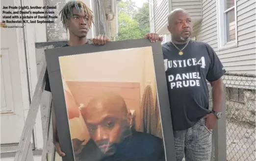  ?? TED SHAFFREY/AP ?? Joe Prude (right), brother of Daniel Prude, and Daniel's nephew Armin stand with a picture of Daniel Prude in Rochester, N.Y., last September.