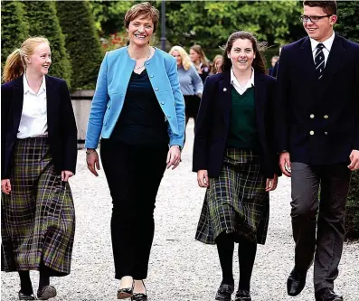  ??  ?? Warning: Lisa Kerr, pictured with pupils, said private schools would be disadvanta­ged