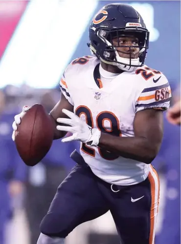  ?? ELSA/GETTY IMAGES ?? On first-and-goal with three seconds left, Tarik Cohen (above) throws a touchdown pass to Anthony Miller (right photo), who celebrates with Bobby Massie (background) and Josh Bellamy (15).