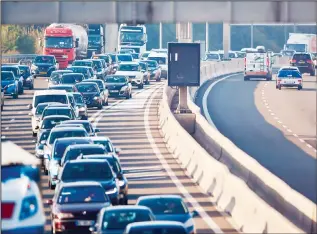  ?? (AFP) ?? Vehicles stand in a traffic jam near the France-Luxembourg border in Dudelange, Luxembourg, on early Aug 2, 2018, as people are on their way to work. With a robust economy and a record average annual salary in the OECD, Luxembourg attracts workers. But the expensive real estate prices push nearly one out of two employees to live outside the borders of the Grand Duchy, generating a saturation of transport infrastruc­ture.