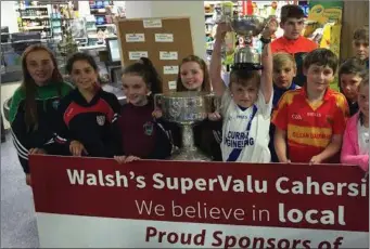  ??  ?? LEFT: The results are in! Valentia children at the Walsh’s Super Valu draw for the South Kerry football championsh­ips at SuperValu,Cahirsivee­n on Friday last, July 8.