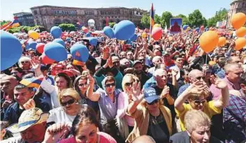  ?? AFP ?? Supporters of Armenian protest leader Nikol Pashinyan attend a rally in downtown Yerevan yesterday. At least 20,000 people rallied in the centre of the Armenian capital.